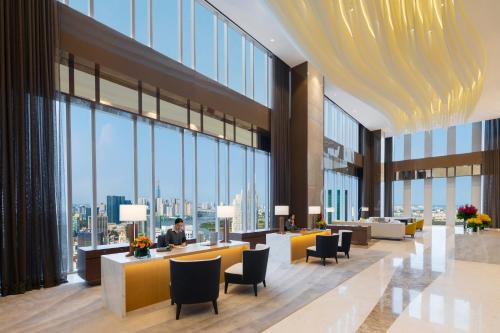 a lobby with a view of a building with windows at Sedona Suites Ho Chi Minh City in Ho Chi Minh City