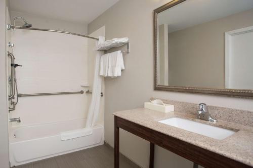 a bathroom with a sink and a shower and a mirror at Best Western York Inn in York