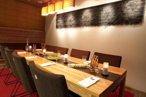 a conference room with a long wooden table and chairs at Rokua Health & Spa in Rokua