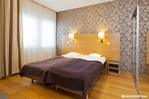 a bedroom with a large bed in a room at Rokua Health & Spa in Rokua