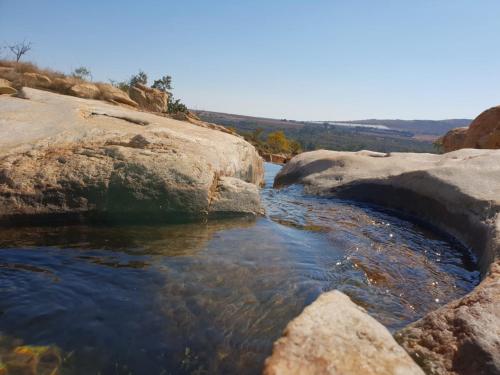 a pool of water between two large rocks at Milorho Lodge in Rietfontein