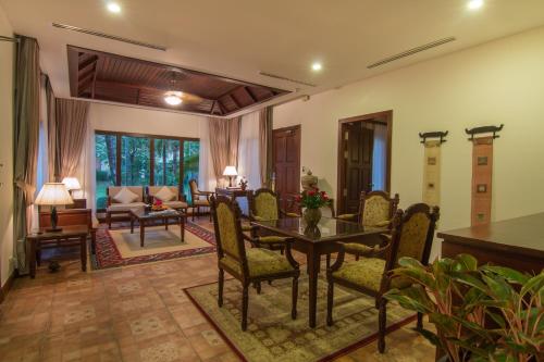 a living room with a table and chairs at Angkor Palace Suite & Villa in Siem Reap