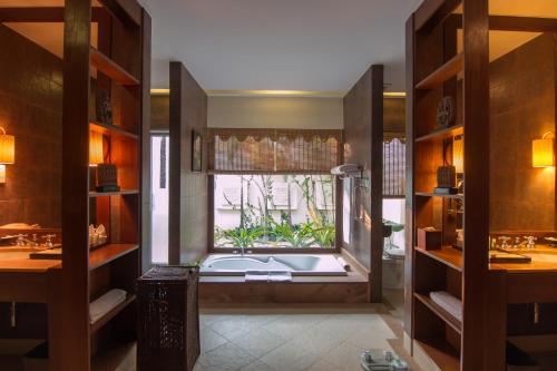 a bathroom with a bath tub in a window at Angkor Palace Suite & Villa in Siem Reap