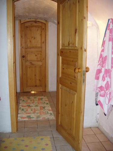 a room with a wooden door and a rug at Villa River Rose in Jõesuu