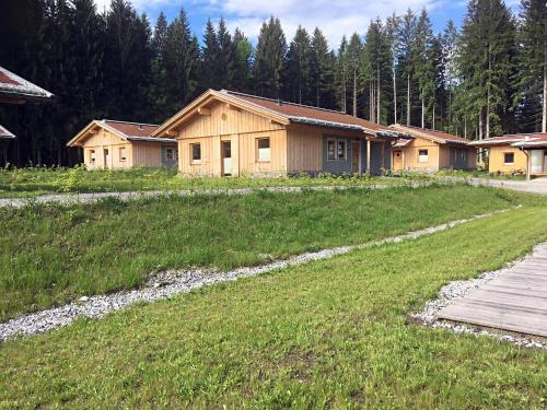 a house in the middle of a grassy field at Dobringers Chalet-Dorf Warös in Hermagor