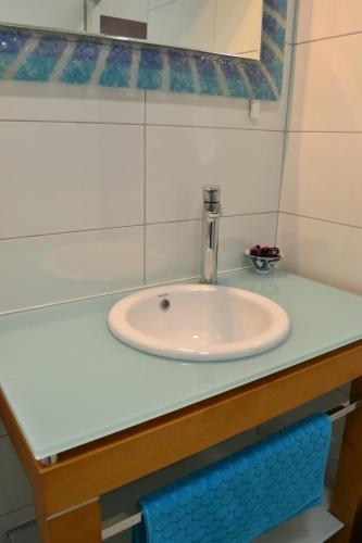 a bathroom counter with a sink and a mirror at Fly Inn in Velika Gorica