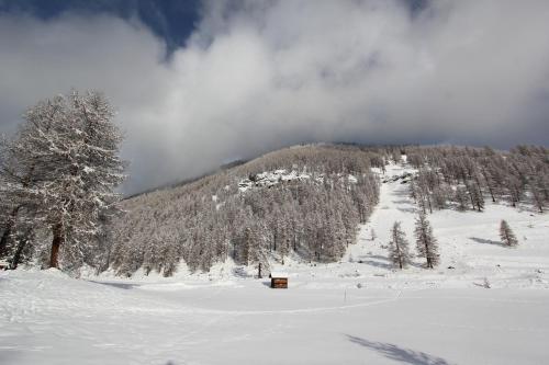 a snow covered mountain with a house on it at Chesa Piz d'Esan in S-chanf