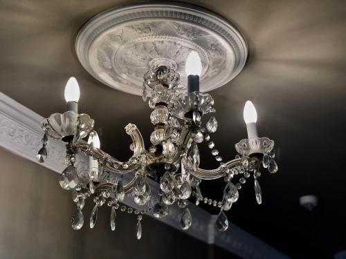 a chandelier is hanging from a ceiling at Merite Hotels Hamburg Altona GmbH in Hamburg