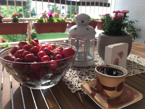 a bowl of fruit and a cup of coffee on a table at Apartman Zora in Bar