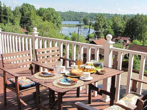 a wooden table with food on a deck with chairs at Volga-Volga in Plyos