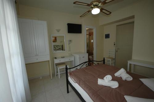 a bedroom with a bed with towels on it at Pension Ocean View in Naxos Chora