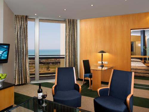 a hotel room with a view of the ocean at Dan Panorama Tel Aviv Hotel in Tel Aviv