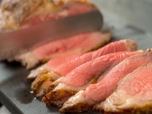 a close up of a bunch of meat on a pan at Art Hotel Hirosaki City in Hirosaki