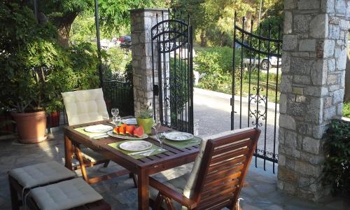 a wooden table with a bowl of fruit on a patio at Lina A & M in Neo Klima