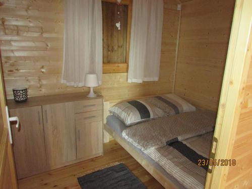 a small room with a bed in a cabin at Witówka Bieliny in Bieliny