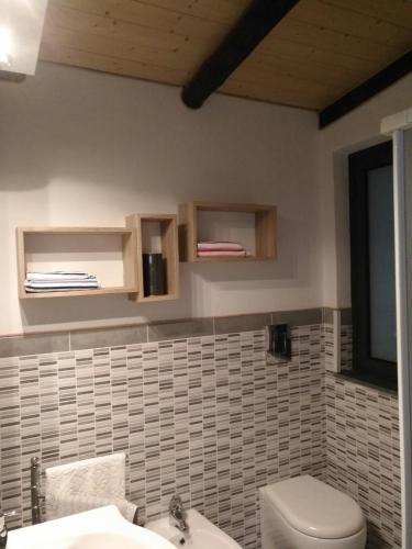 a bathroom with a toilet and a sink at Casa della Quercia in San Giovanni la Punta