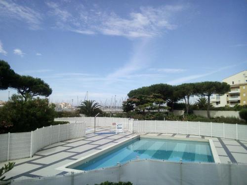 a swimming pool on top of a building at T3 Duplex, centre port, clim, garage, piscine in Cap d'Agde