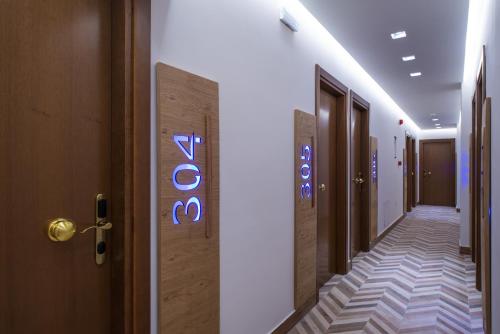 a hallway with a sign on the side of a building at Anesis Blue Boutique Hotel in Hersonissos