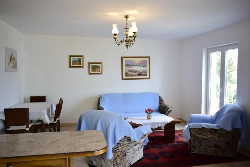 ein Wohnzimmer mit einem blauen Sofa und einem Tisch in der Unterkunft Apartment Diana in Vantačići