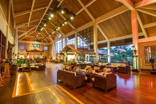 a large lobby with people sitting on couches at Angkor Palace Suite & Villa in Siem Reap