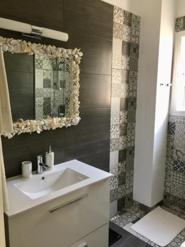 a bathroom with a sink and a mirror at Vangelios Apartments in Paphos