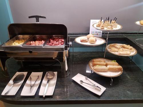 a buffet with different types of food on plates at Silken Reino de Aragón in Zaragoza