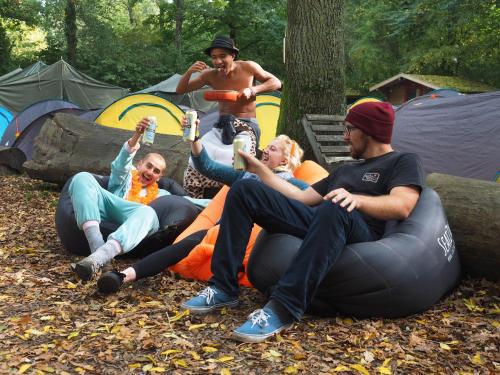a group of people sitting on bean bags in front of tents at Festanation Oktoberfest Camp #2 in Munich