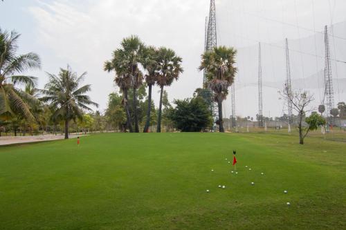 a person in a park with balls on the grass at Angkor Palace Suite & Villa in Siem Reap