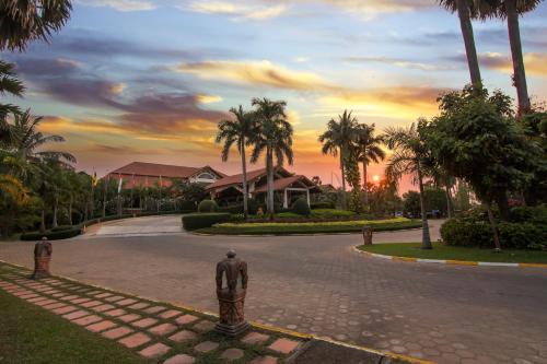 a street with a statue in the middle of a road at Angkor Palace Suite & Villa in Siem Reap