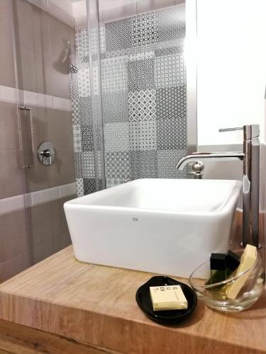 a white bath tub on a wooden counter in a bathroom at Casa Busari in Palermo