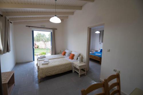 a bedroom with a bed and a room with a window at Electra Studios in Gerani Chanion