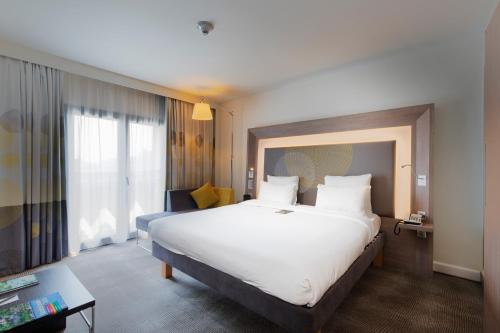 a hotel room with a large bed and a window at Novotel Istanbul Bosphorus Hotel in Istanbul