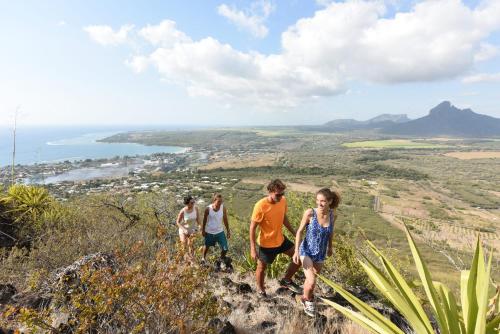a group of people walking up a hill at Veranda Tamarin Hotel & Spa in Tamarin