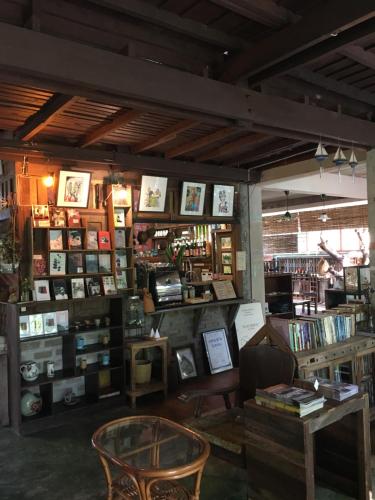 a book store with a table and chairs and books at Banban Nannan Library and Guesthome in Nan