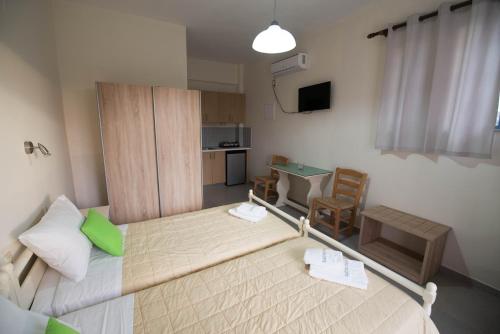 a small room with a bed and a table and chairs at Electra Studios in Gerani Chanion