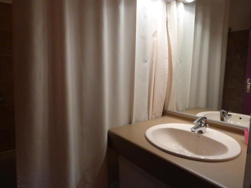 a bathroom with a sink and a mirror at JAUSIERS VILLAGE G 2 in Jausiers