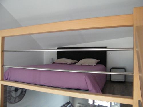 a bunk bed with two pillows on top of it at Bel appartement vue sur mer in Cancale