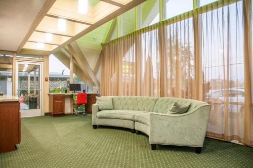 a living room with a couch in front of a window at Hotel Calle Joaquin - San Luis Obispo in San Luis Obispo