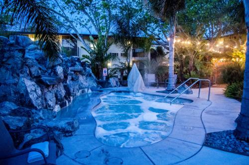 a swimming pool in a resort at night at Hotel Calle Joaquin - San Luis Obispo in San Luis Obispo