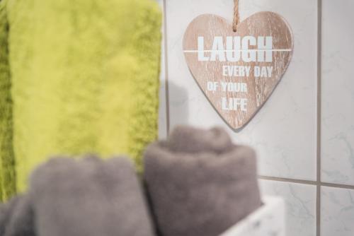 a heart sign on the wall of a store at MOOKI Mountain & Pool Gerlitzen Apartment in Kanzelhöhe
