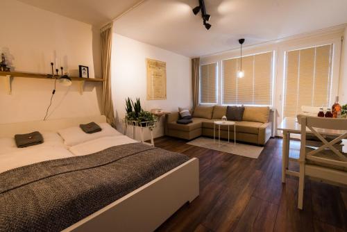 a bedroom with a bed and a living room at MOOKI Mountain & Pool Gerlitzen Apartment in Kanzelhöhe