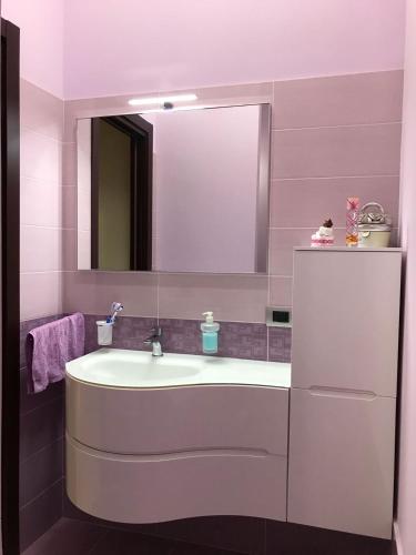 a bathroom with a sink and a mirror at Casa Angela in Avola