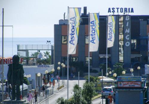 a group of flags on a street in front of a building at Casa Lucia Centro Apartment Deluxe in Sottomarina