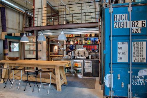 a kitchen with a wooden table in a room at Anda Venice Hostel in Mestre