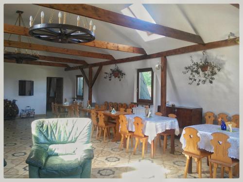 a dining room with tables and chairs and a ceiling at Agroturystyka Leszczynowy Dworek in Ponikwa