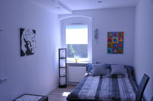 a bedroom with a bed and a window in it at Apartamenty Centrum Słupsk in Słupsk