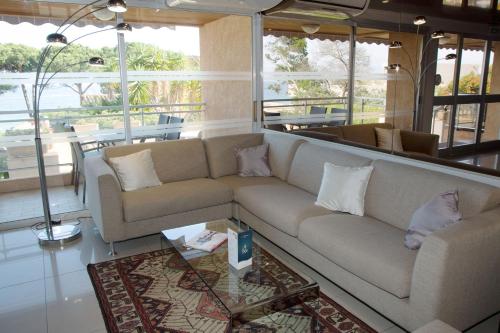 a living room with a couch and a table at Hôtel La Pinède in Ajaccio