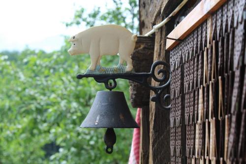 a bell with a pig on the side of a building at Къща за гости Ножери in Tryavna