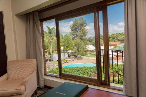 a room with a window looking out at a pool at Sunbird Capital in Lilongwe