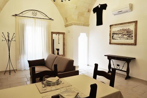 a living room with a couch and a table at Antica Oria in Oria